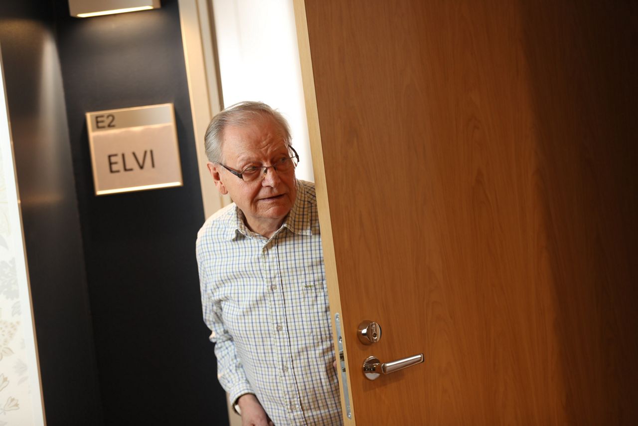 Old man peeking from a nursing home room door