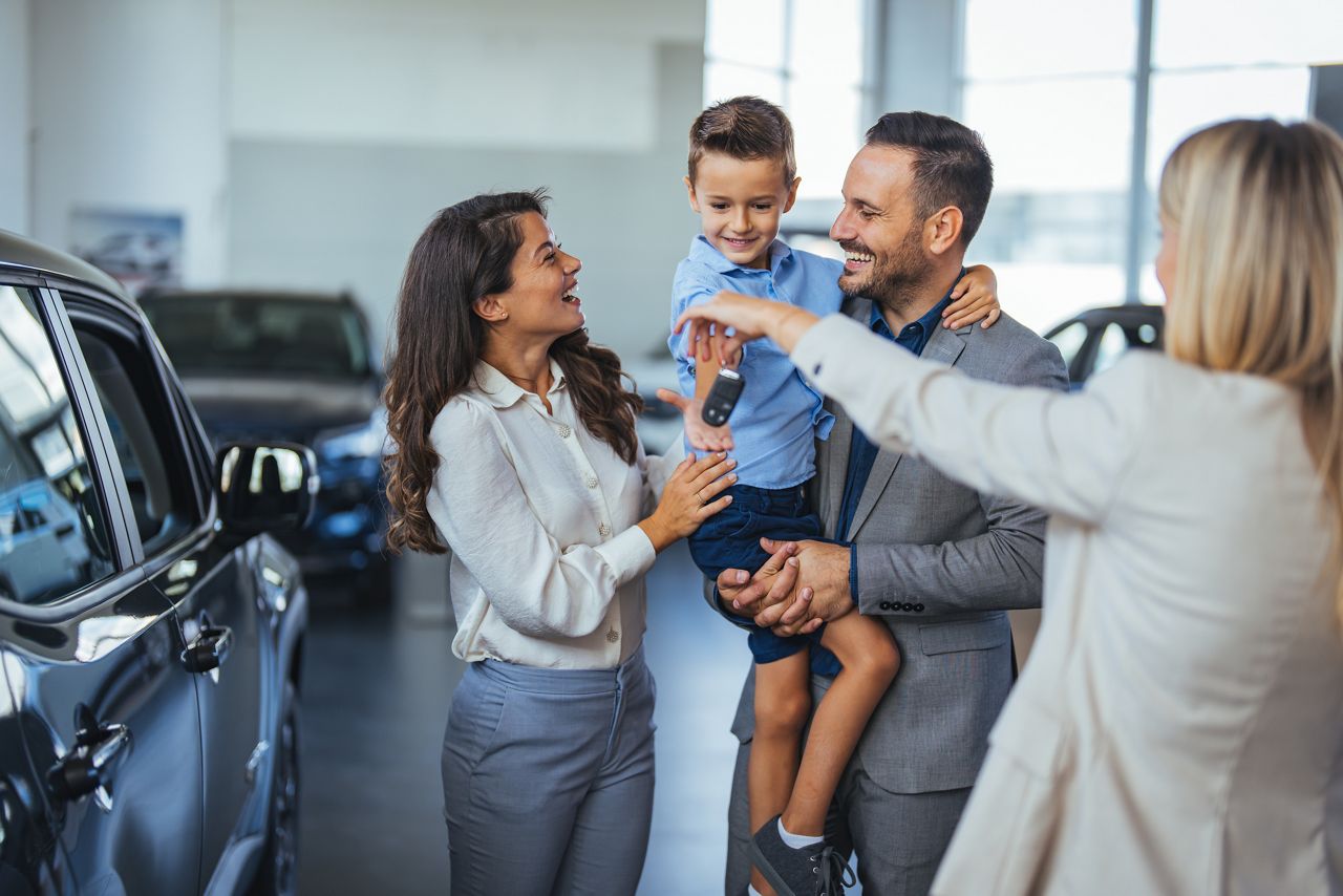 Family receiving keys for a new car