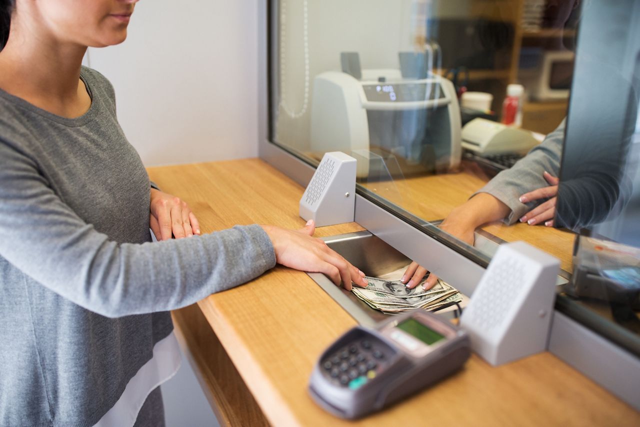 Bank teller and customer making a transaction