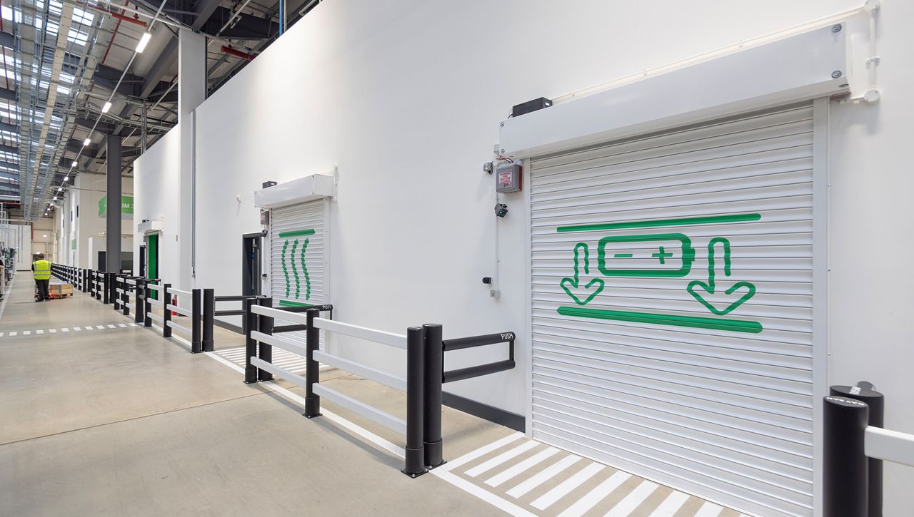 Image: A row of fire rated roller shutters in the down position in a manufacturing environment