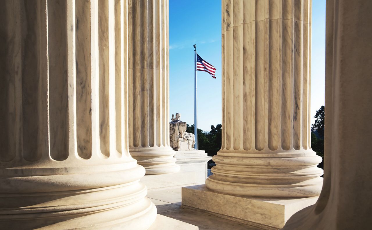 Marble columns with American flag in background