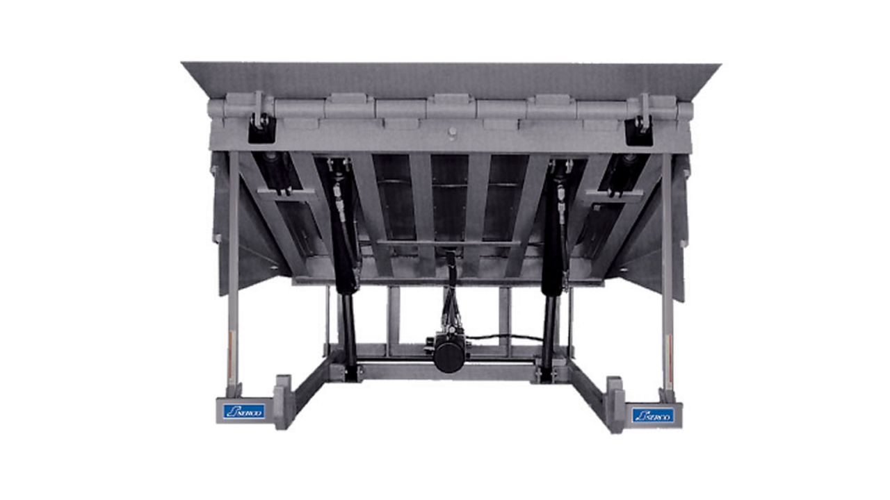 A silver hydraulic dock leveler with a top panel.