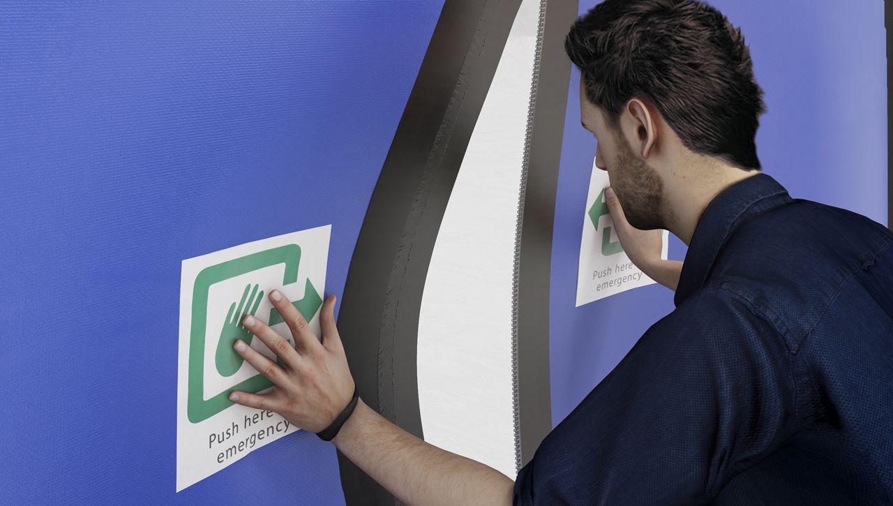 Image: A ASSA ABLOY high speed door for emergency exits being pushed open by a pedestrain