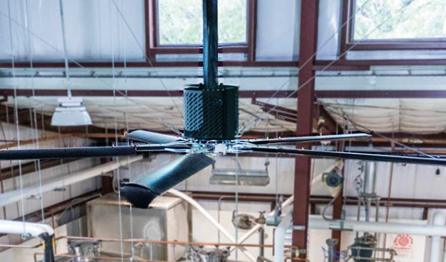 A black and silver fan installed over a brewery
