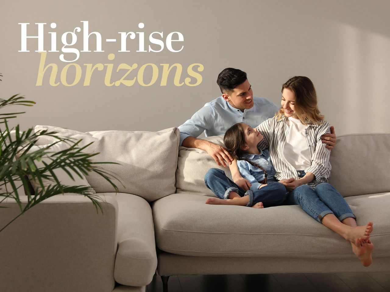 Family sitting on sofa in luxury apartment