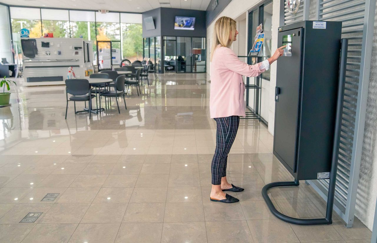 Woman using a KEYper electronic key cabinet