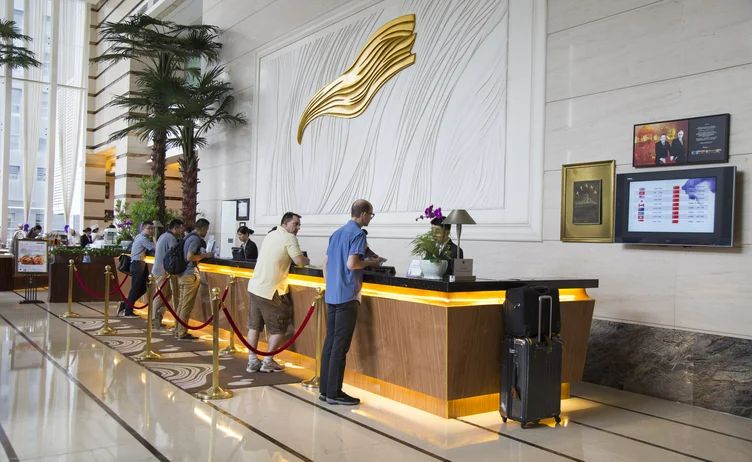 A group of people standing together near the hotel's front desk