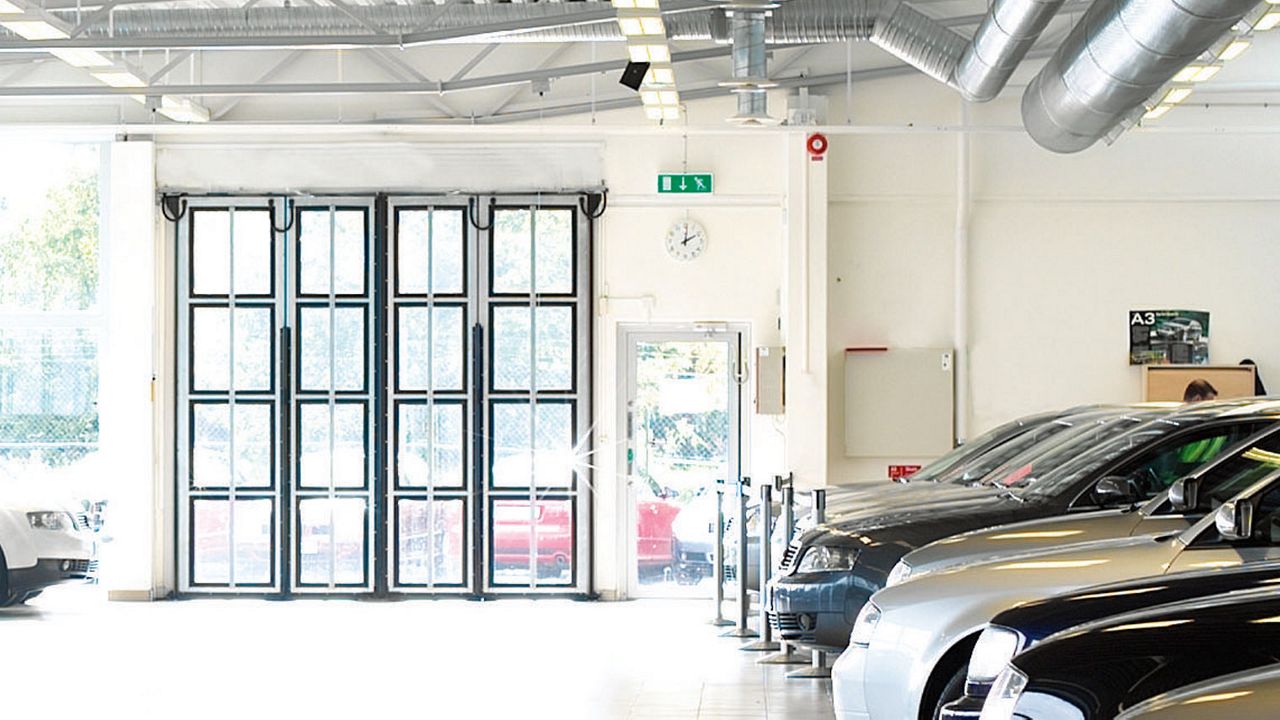 Closed folding doors in a car dealership.