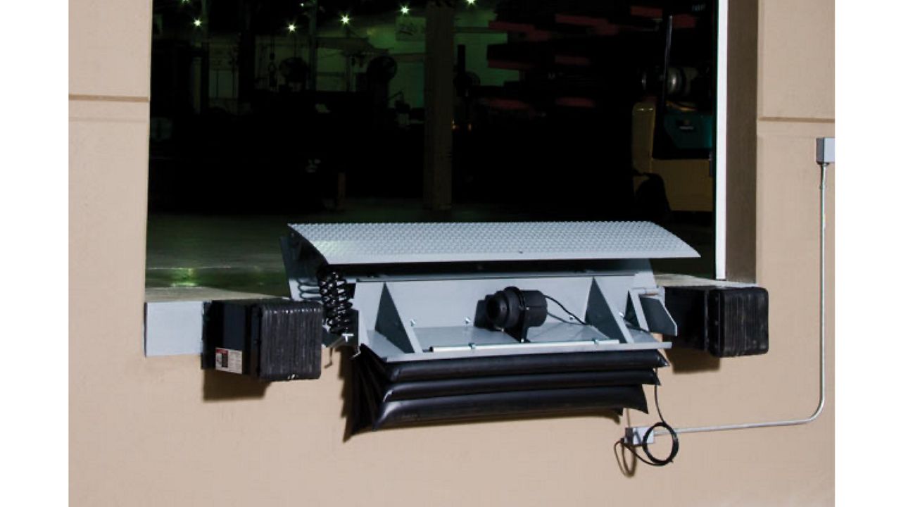 Push-button air-powered edge of dock leveler in use outside.