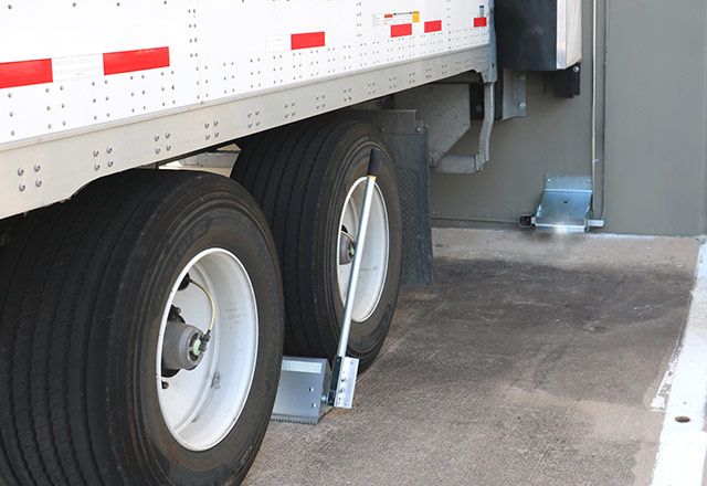 The Kelley VERSACHOCK™ Wheel Chock holding a semi truck in place