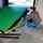  A man installing a green and black dock seal on a green dock leveler