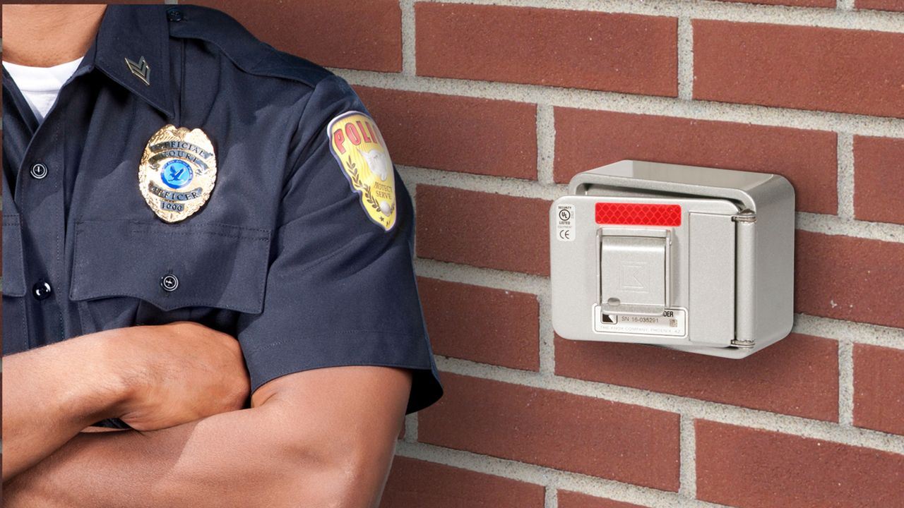 Knox Box emergency access key box and police officer