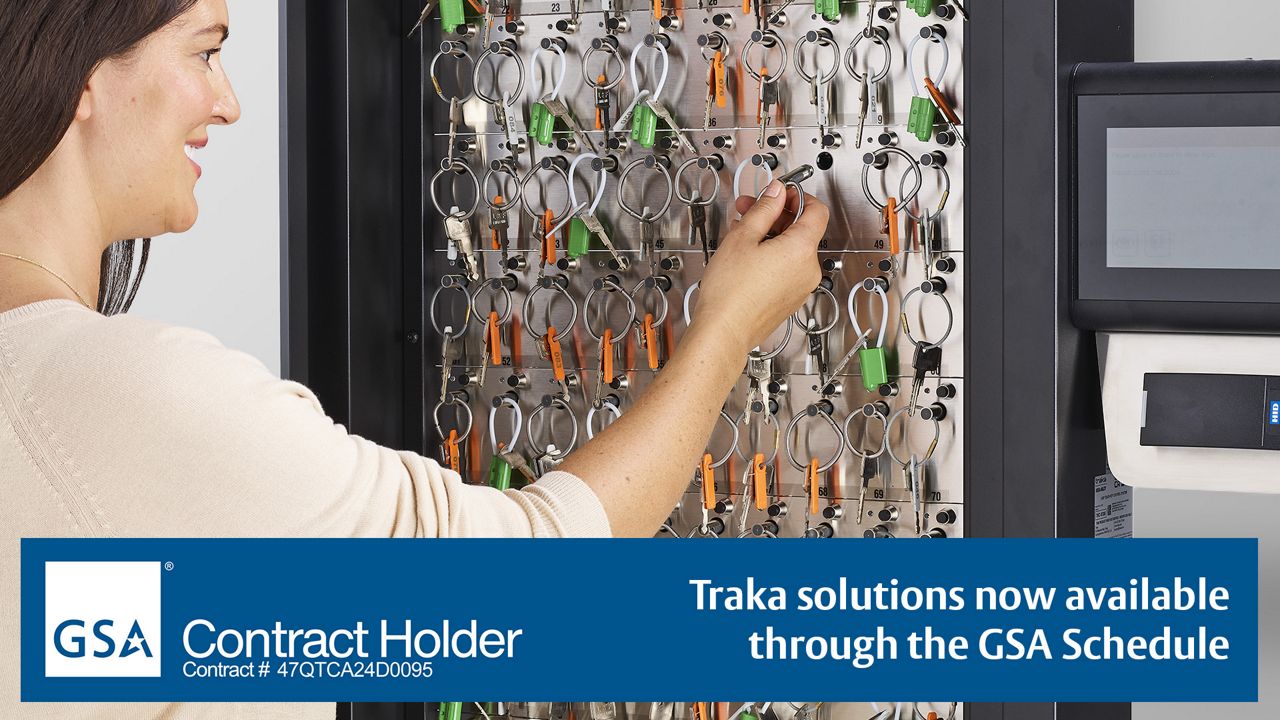 Woman removing a key from a Traka key cabinet
