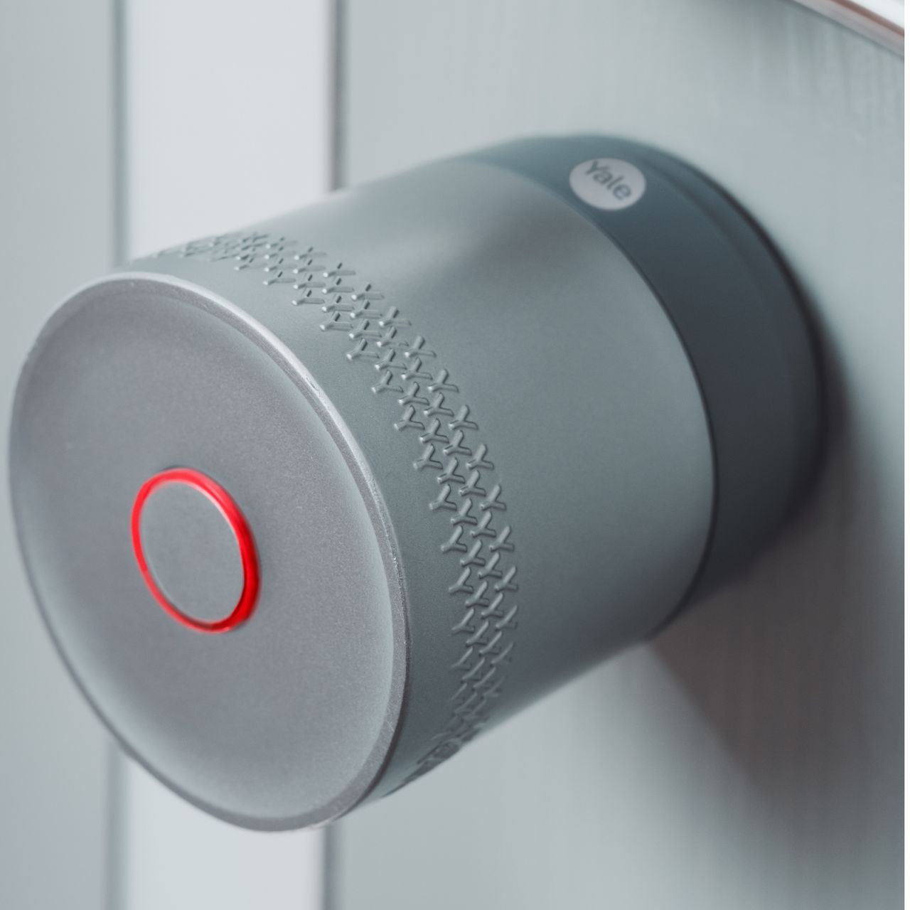 Image: Smart lock controlled via Yale Home App showing locked status beside modern door handle