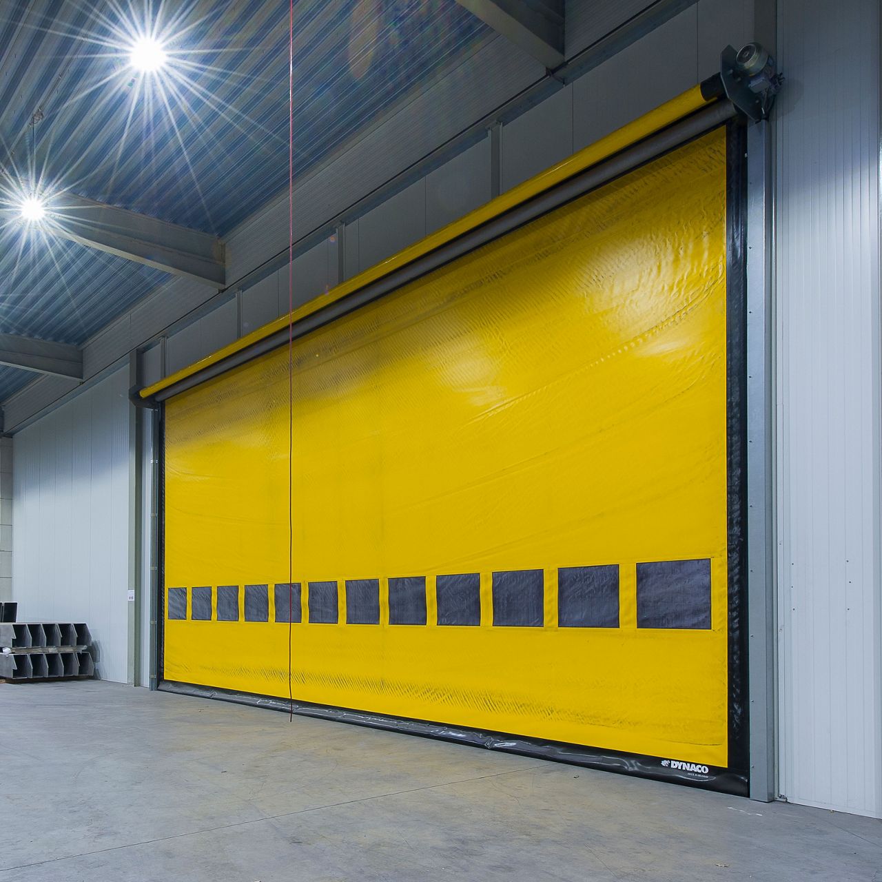 A picture of a wide yellow interior high speed door.