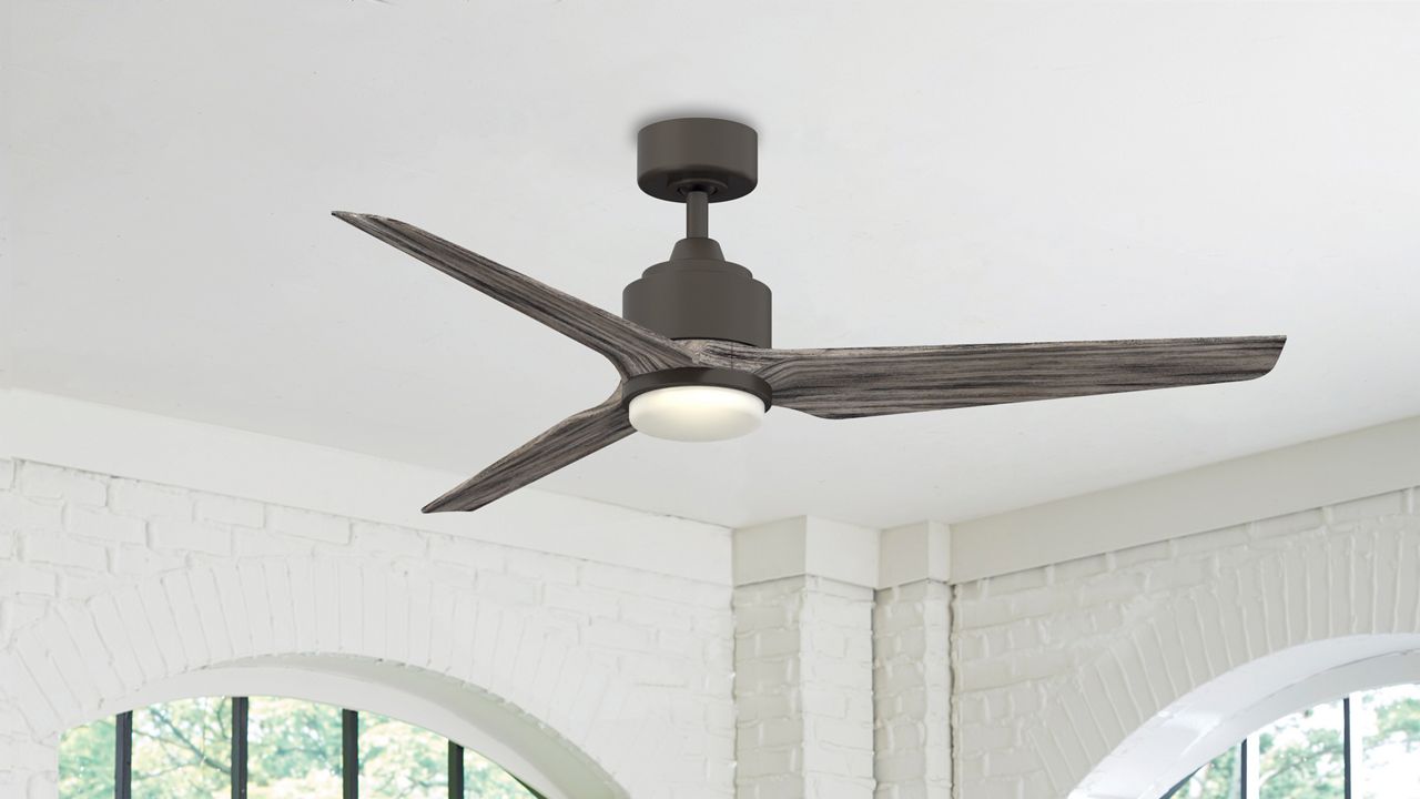 Image: A black TriAire Residential Fan hanging from a white ceiling. 