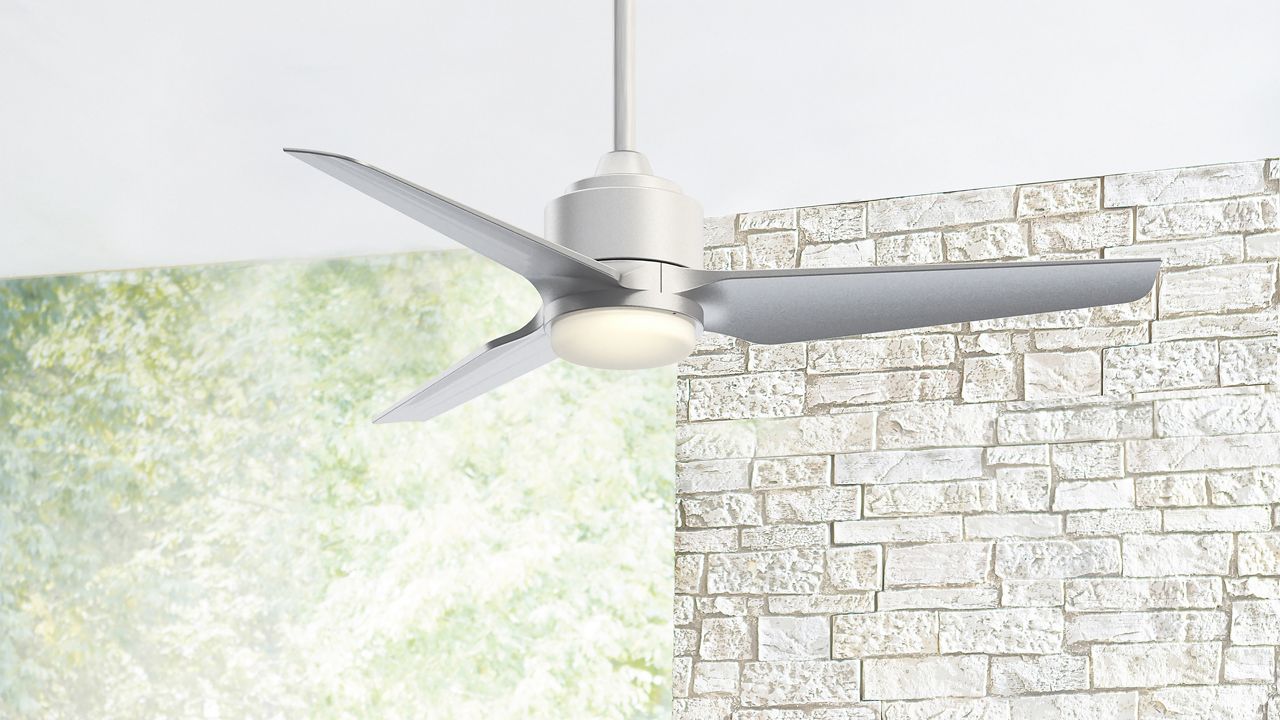 Image: A silver TriAire Residential Fan hanging from a white ceiling. 