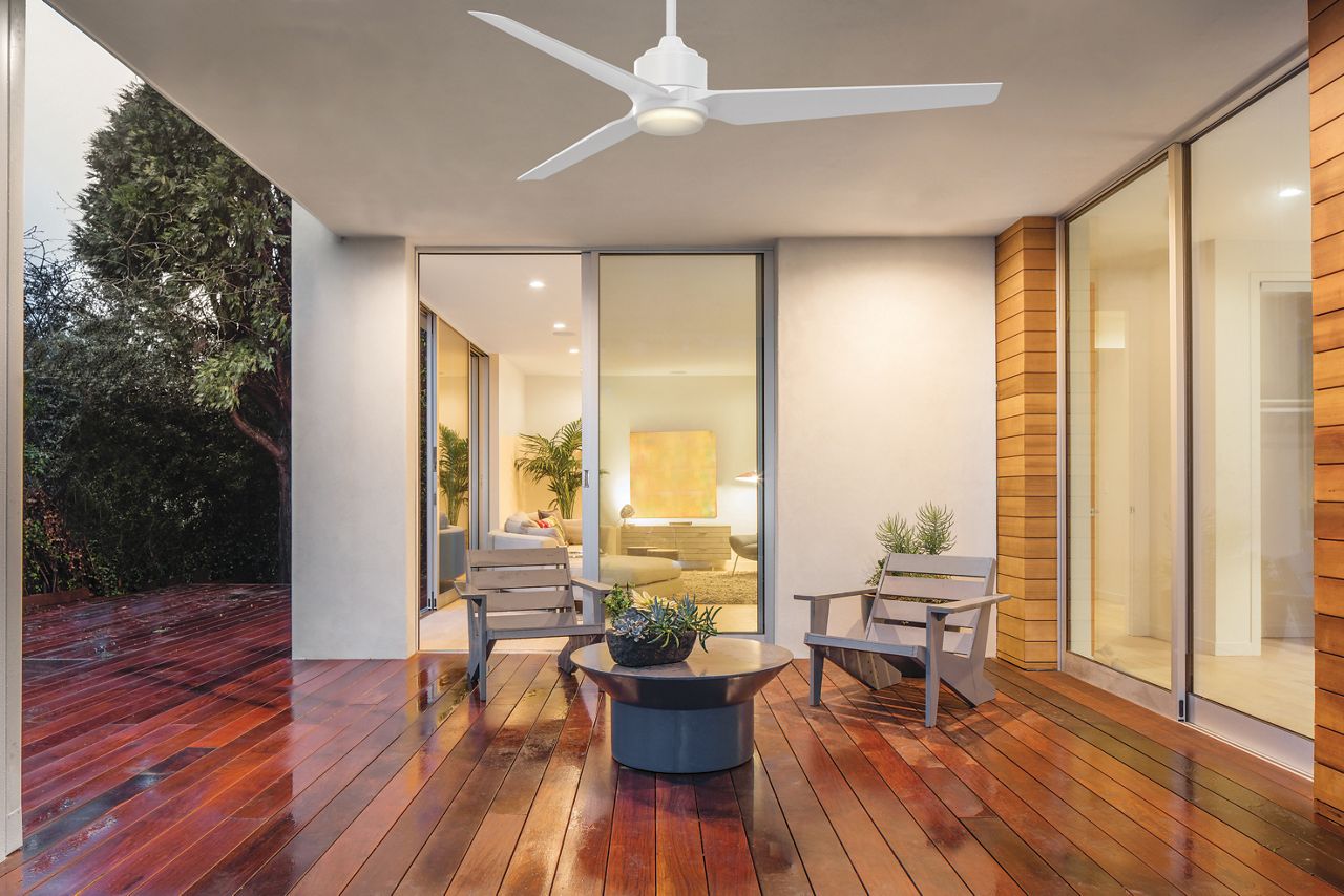 Image: A black TriAire Residential Fan hanging outside on a covered deck.