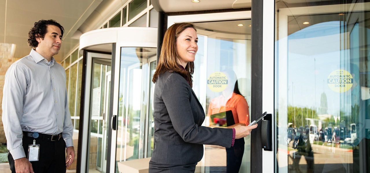 Man And Woman Accessing Revolving Door