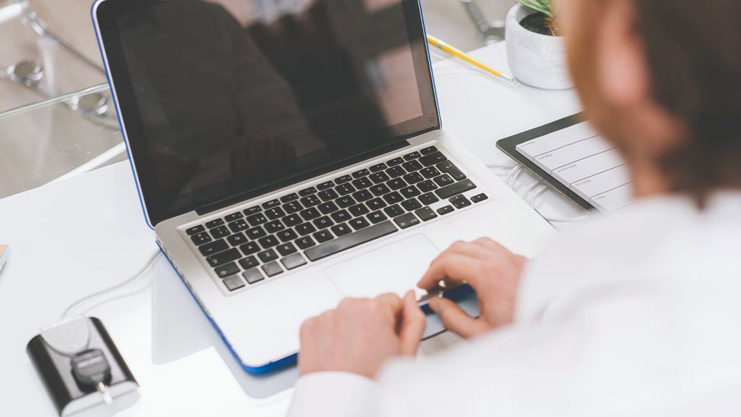 Person sitting in front of laptop.