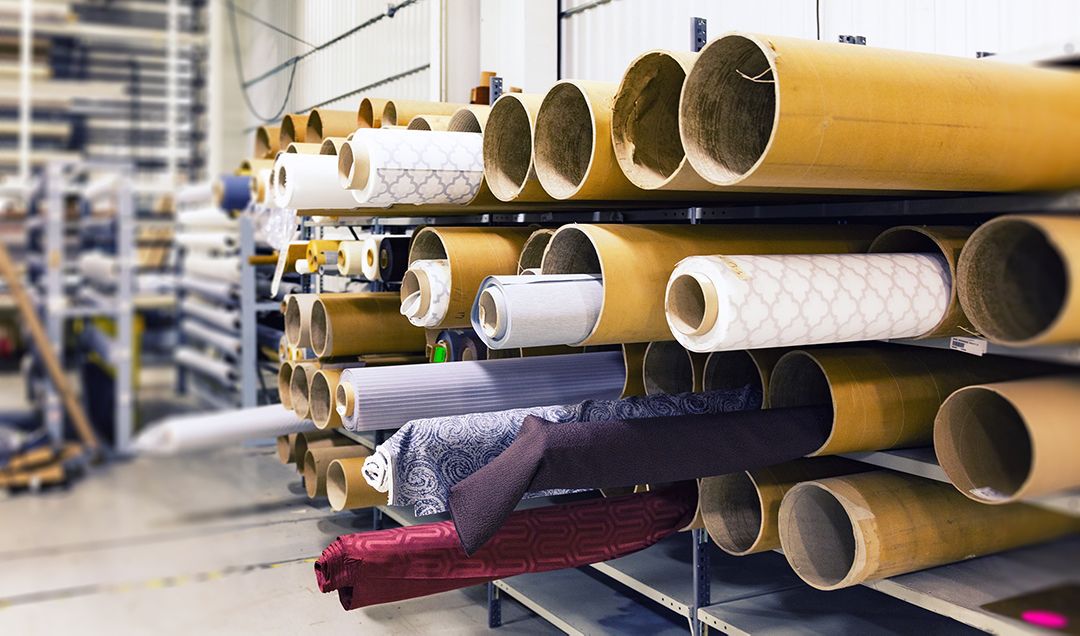 Large rolls of fabric in a manufacturing facility.