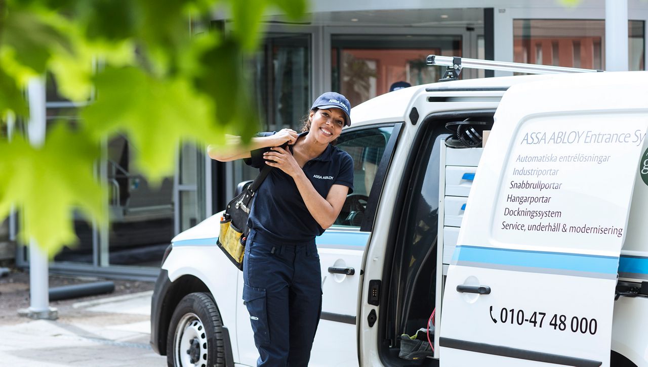 Woman technician outside white service vehicle