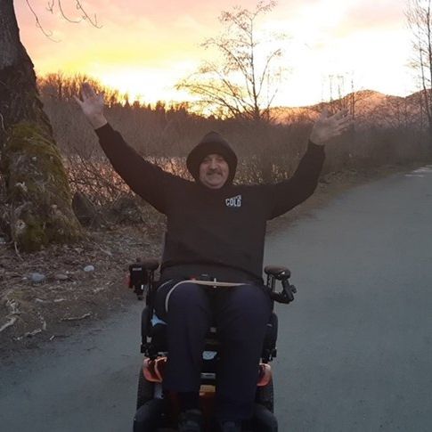 A person with a disability celebrates when he receives an automatic door