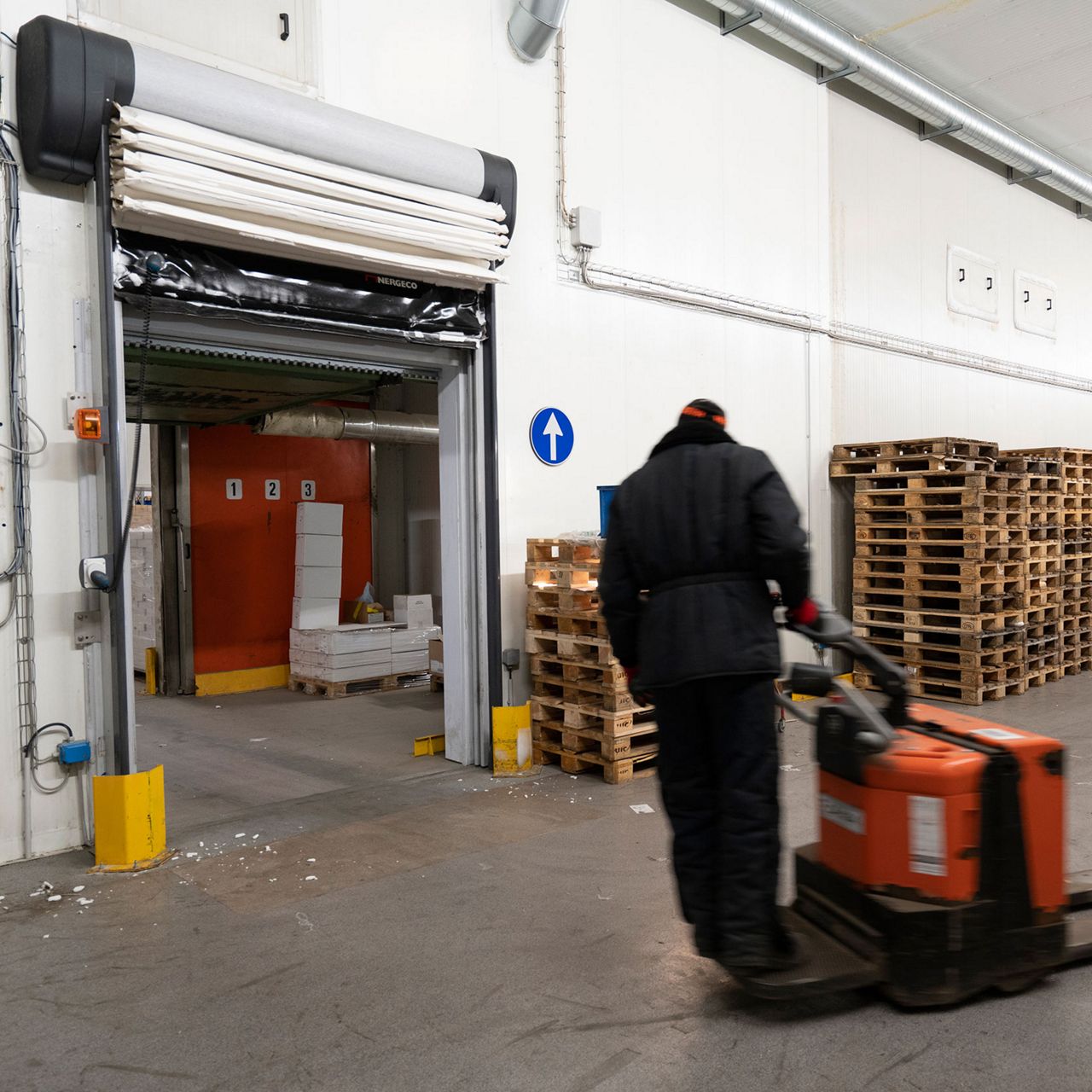 A white freezer door and a fork lift truck.