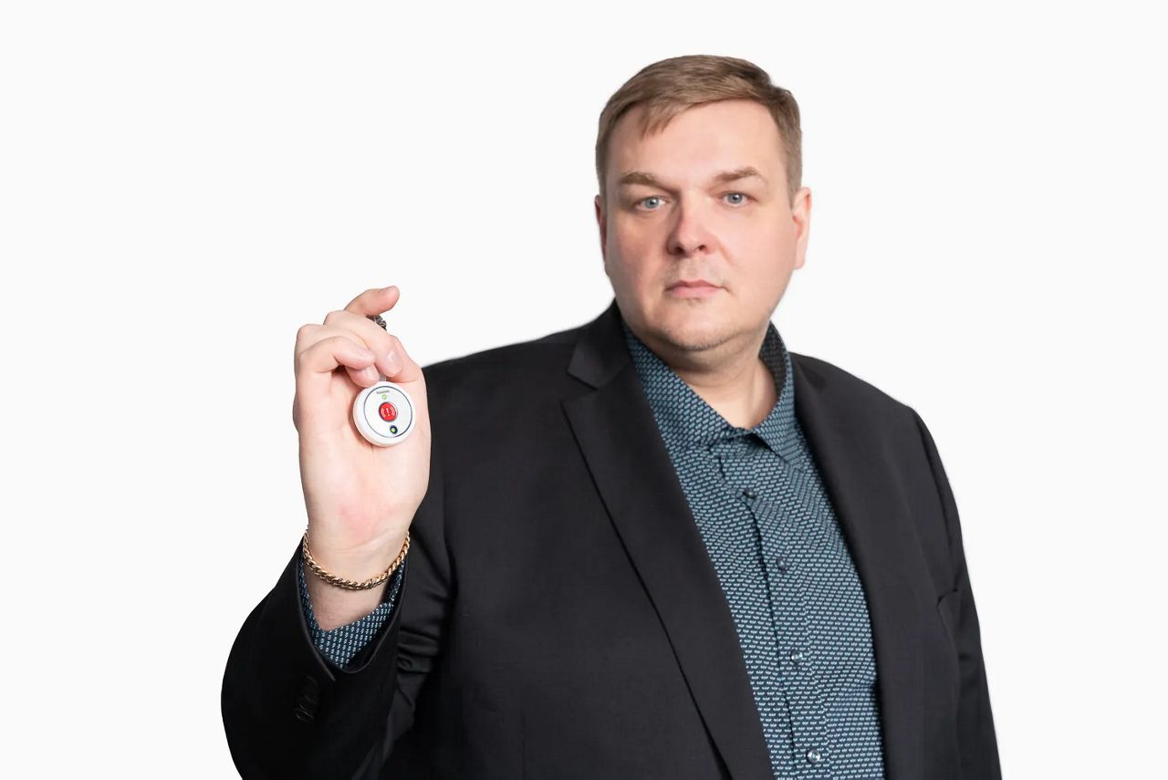 9Solutions Founder Sami Herrala holding 9Solutions safety tag