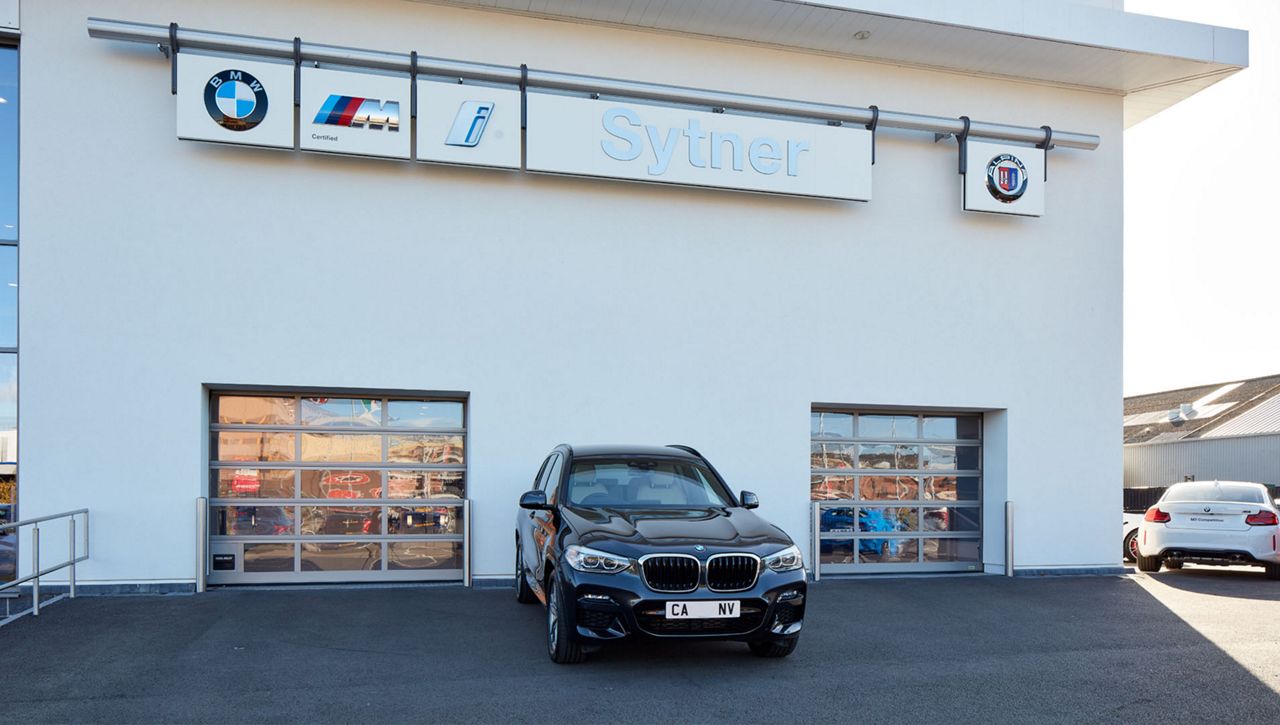 External image of two Crawford OH1042F Overhead Sectional Door at BMW car dealership in the UK