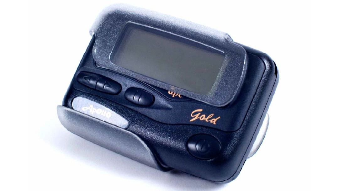 appollo gold pager on a white background