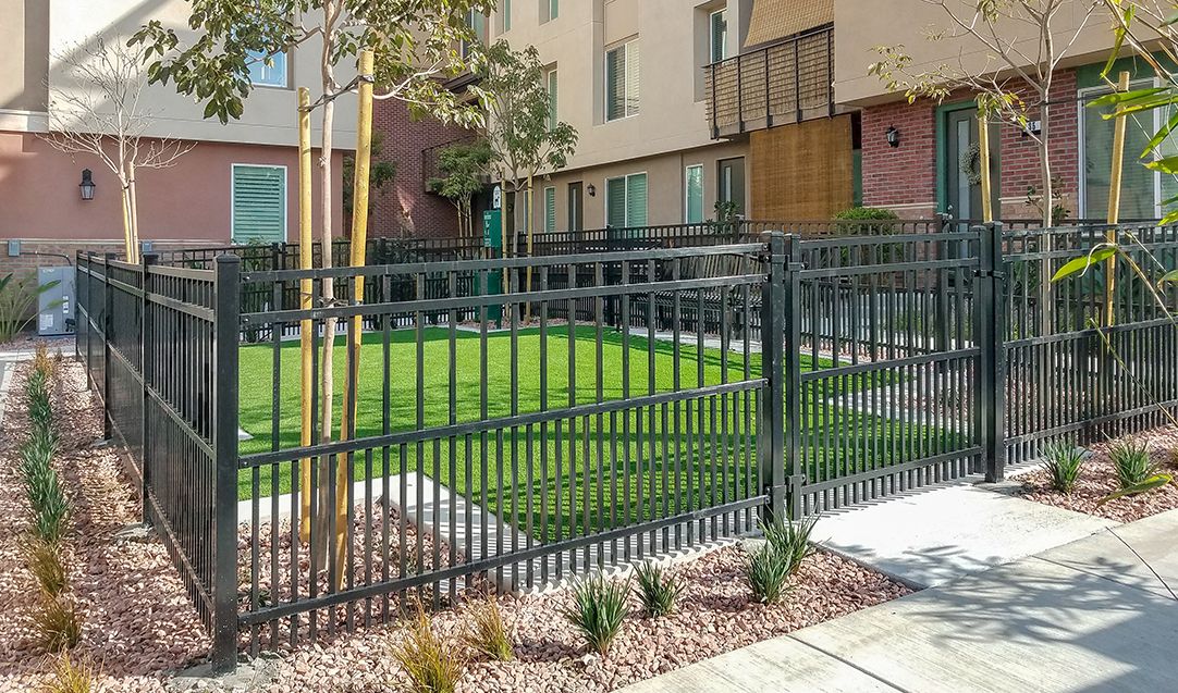 Echelon Plus puppy panel fence in majestic style around a dog park at an apartment complex.