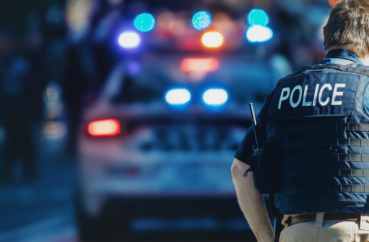 Police officer walking towards partol car
