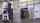 A small forklift picking up a stack of boxes in a warehouse