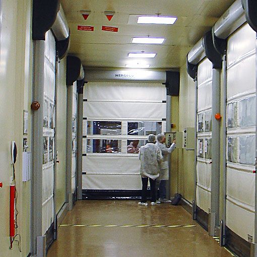 A corridor with white doors and two workers. 