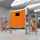 Porta di protezione macchine ASSA ABLOY RP400 arancione aperta con macchine che lavorano dietro una recinzione