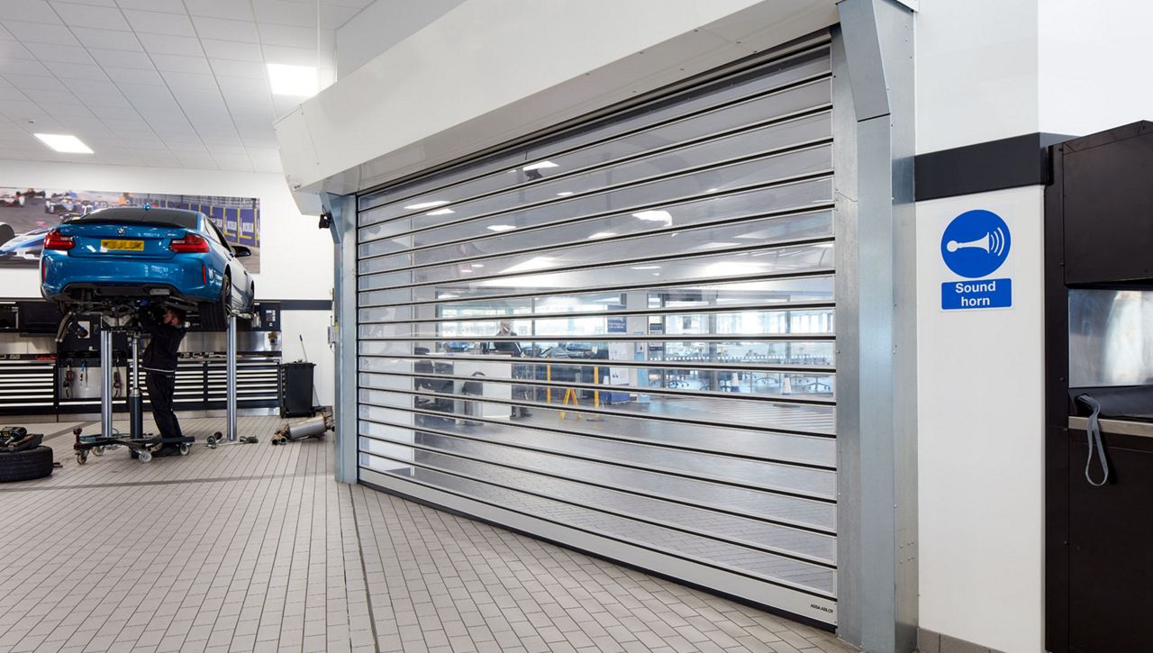 MOT service bay with an RR3000 ISO high speed door at a BMW car dealership