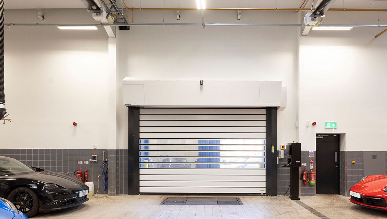 Image: Internal view of an ASSA ABLOY RR5000 Insulated Exterior Door at a Porsche car dealership