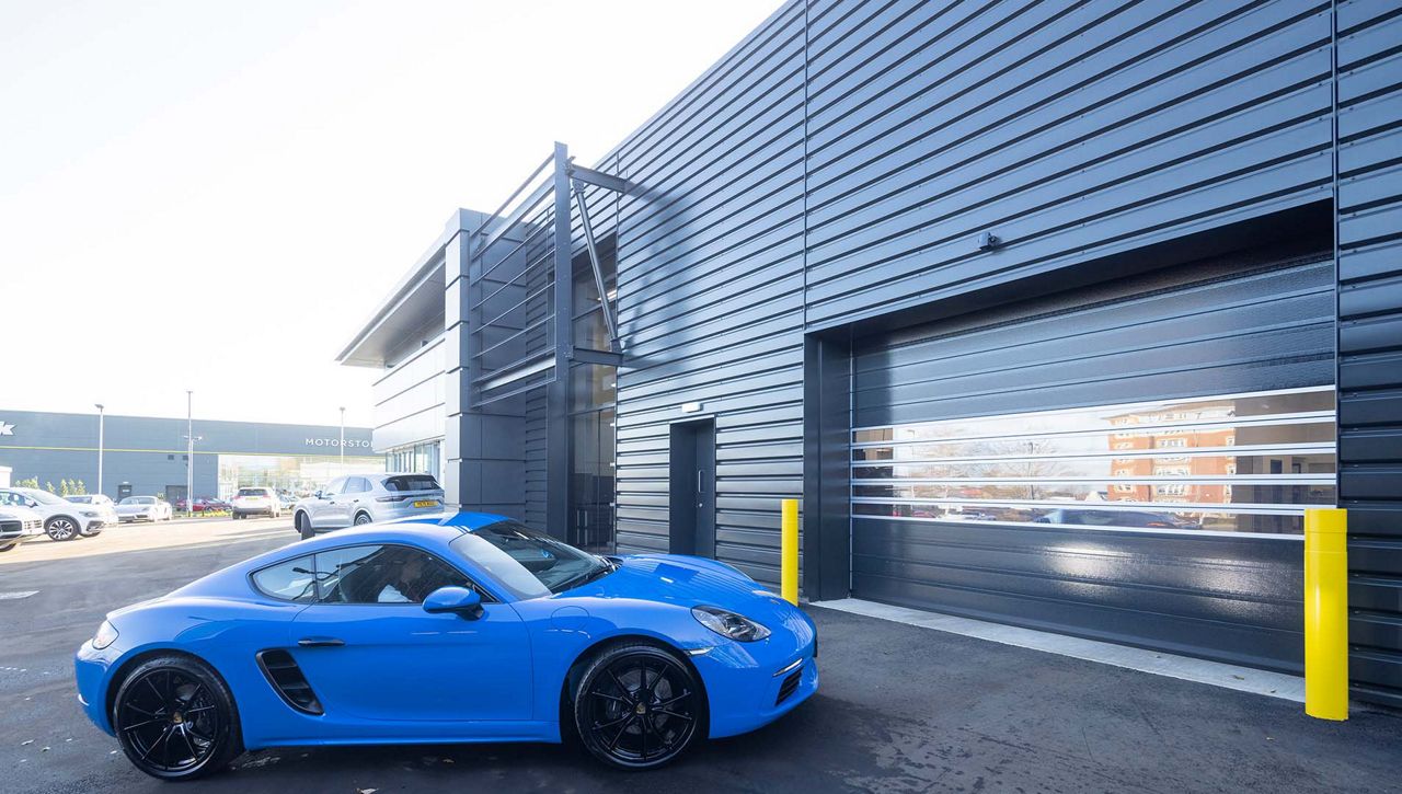 Image: External view of an ASSA ABLOY RR5000 Insulated Exterior Door at a Porsche car dealership