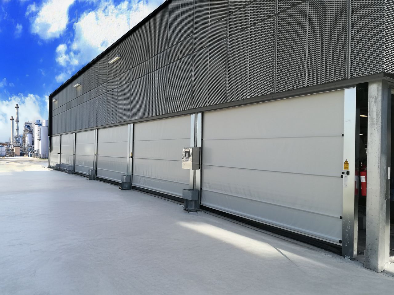 Grey industrial high speed door within an industrial setting