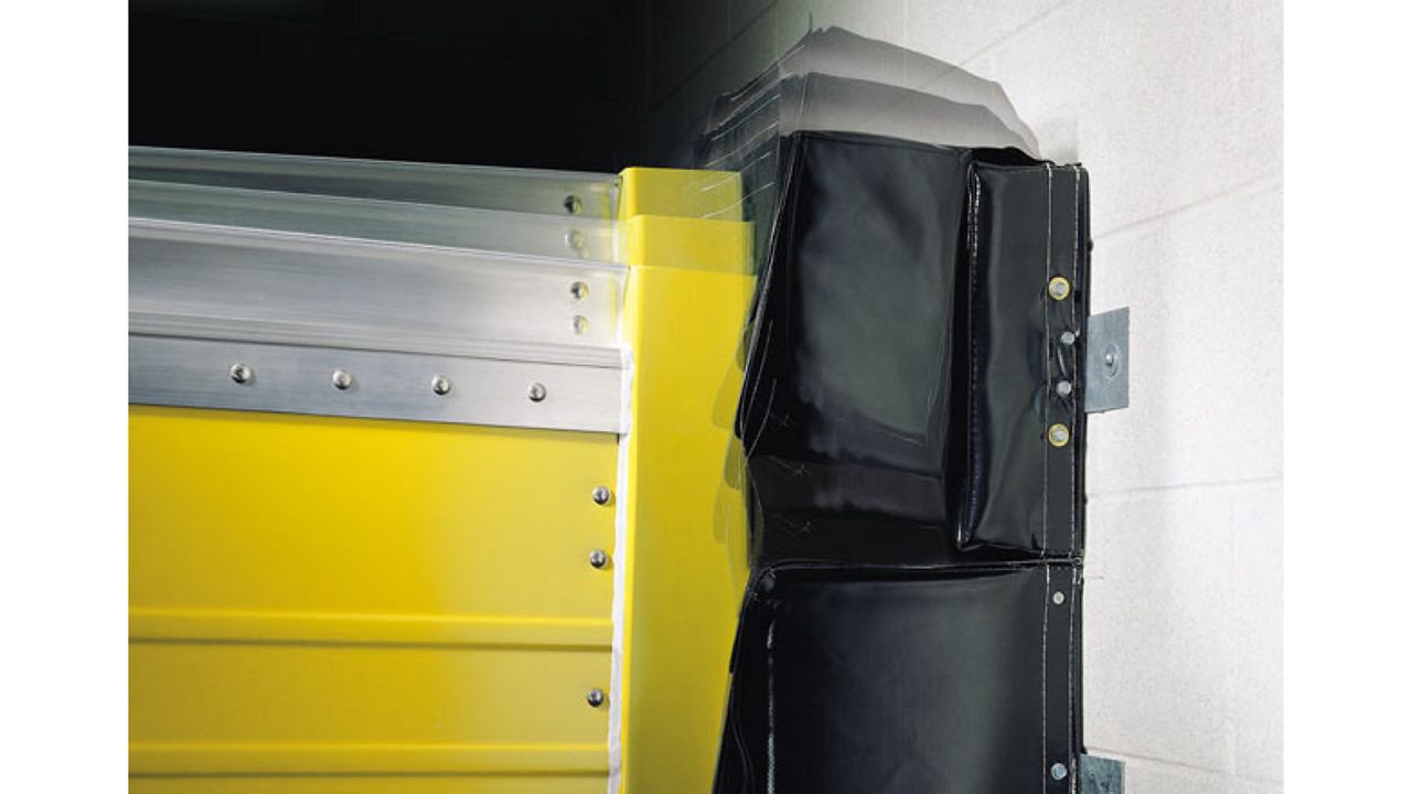 A close up view of a dock seal on a yellow door.