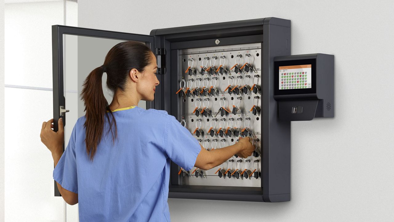 Nurse accessing keys from Traka Touch Pro S key cabinet