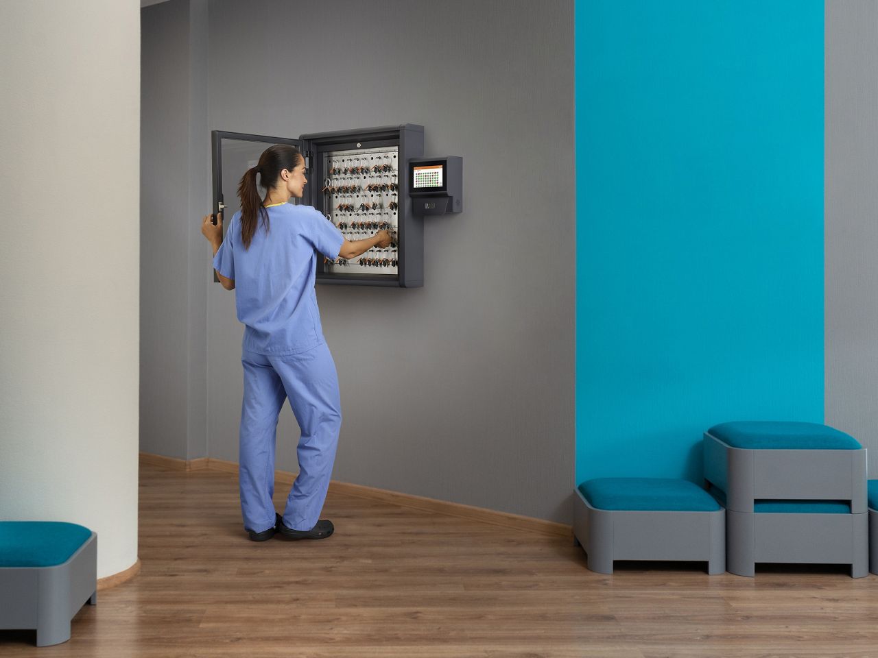 Healthcare worker removing key from Traka Touch Pro key cabinet
