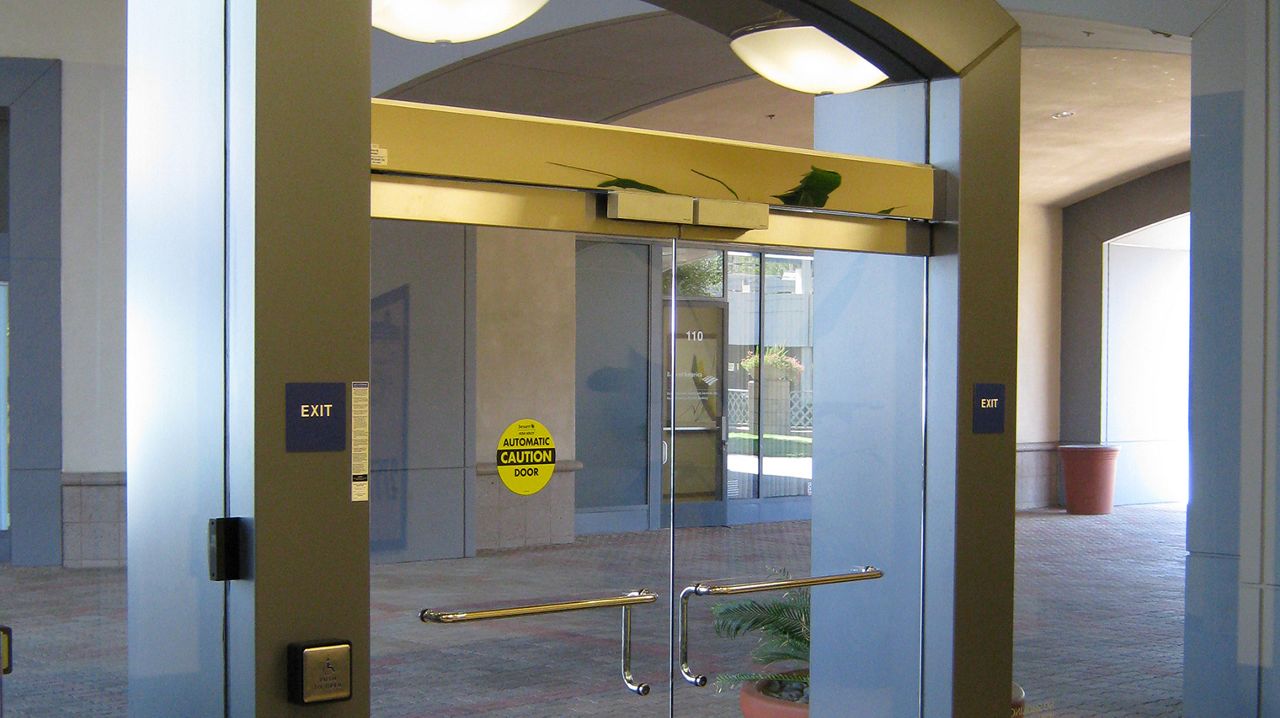 Frontview of the ASSA ABLOY SW200 overhead concealed automatic swing door operator.