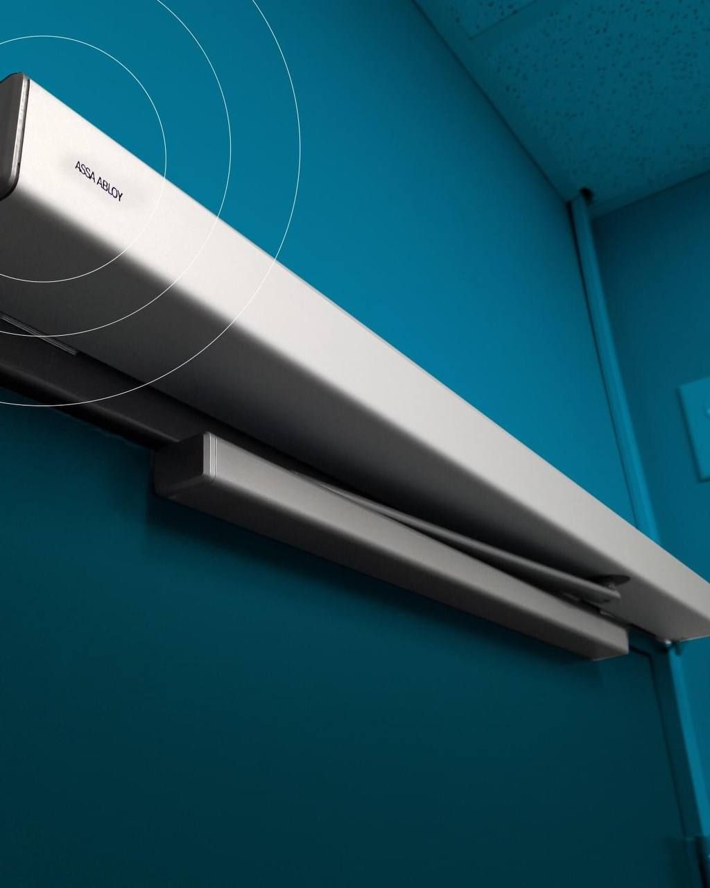 Close-up of the ASSA ABLOY SW60 Swing Door Operator on a brown wooden door.