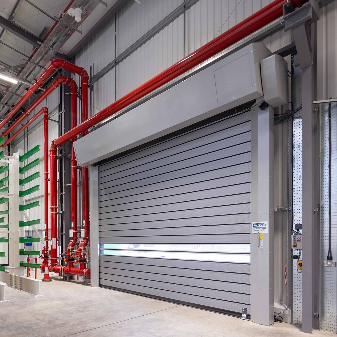 An ASSA ABLOY RR5000 high speed door installed on the exterior of a manufacturing facility