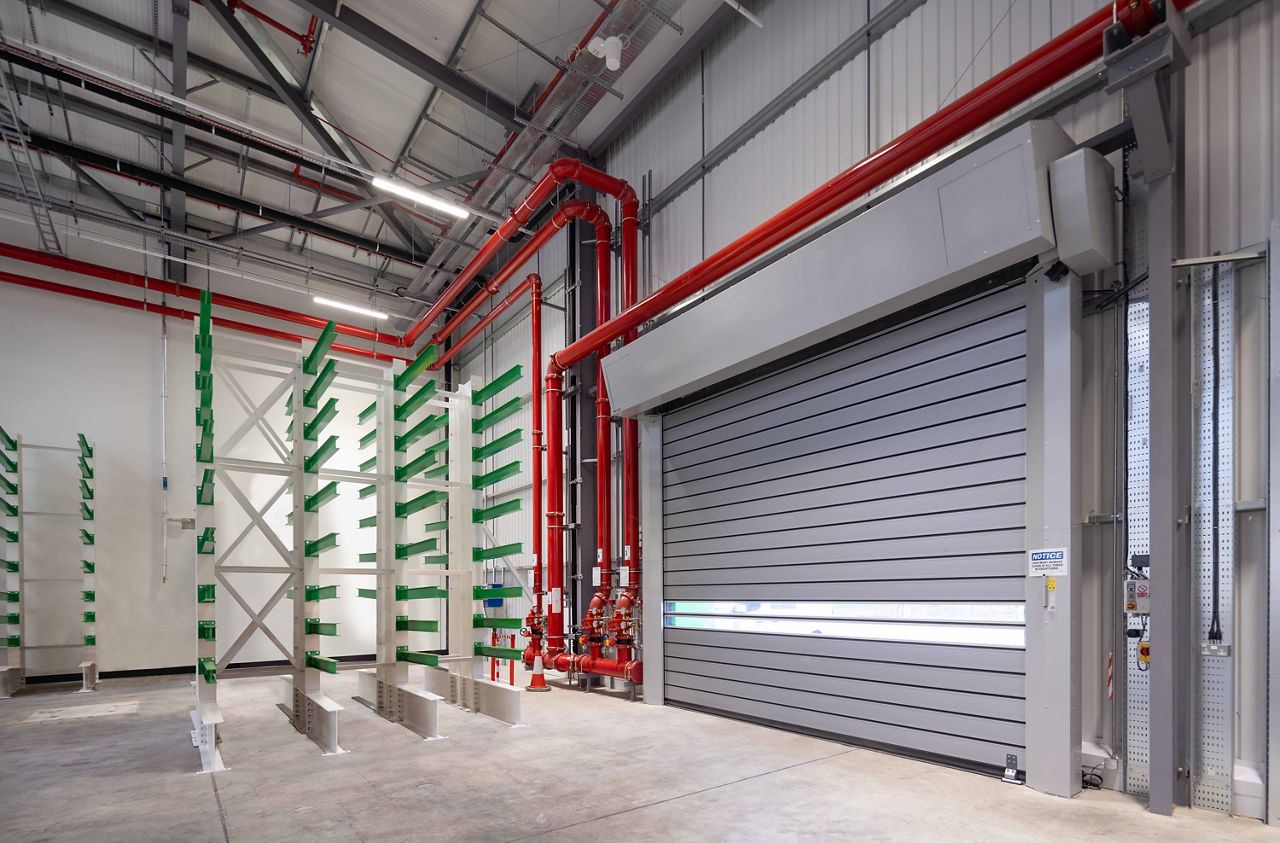 An ASSA ABLOY RR5000 high speed door installed on the exterior of a manufacturing facility