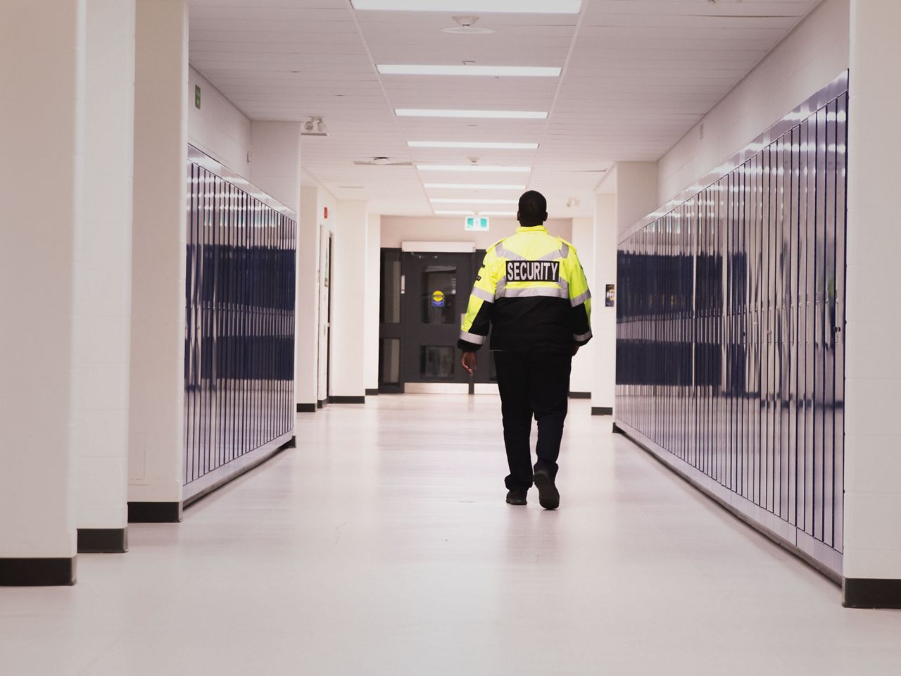 Resource officer walking down a school corridor