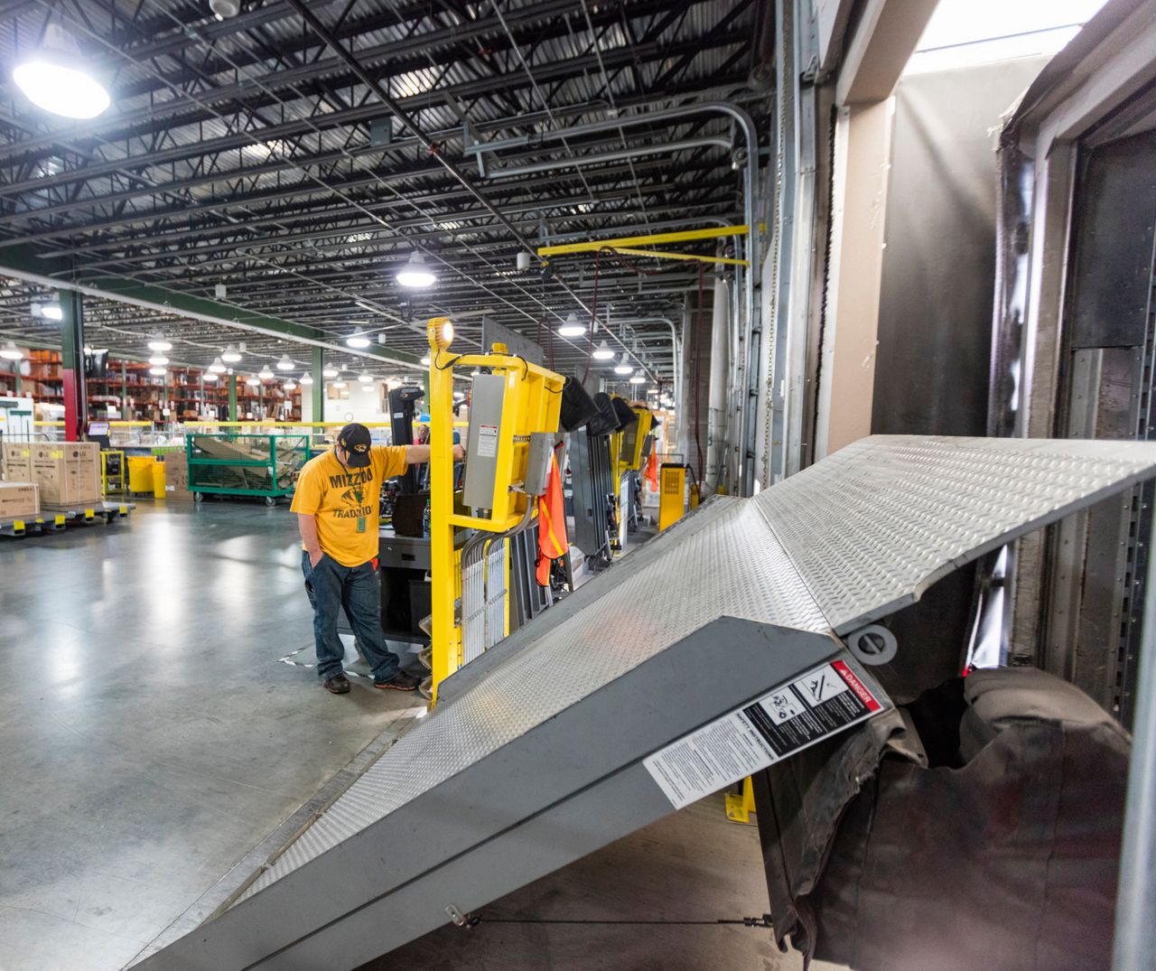 A worker in a warehouse using Serco dock levelers