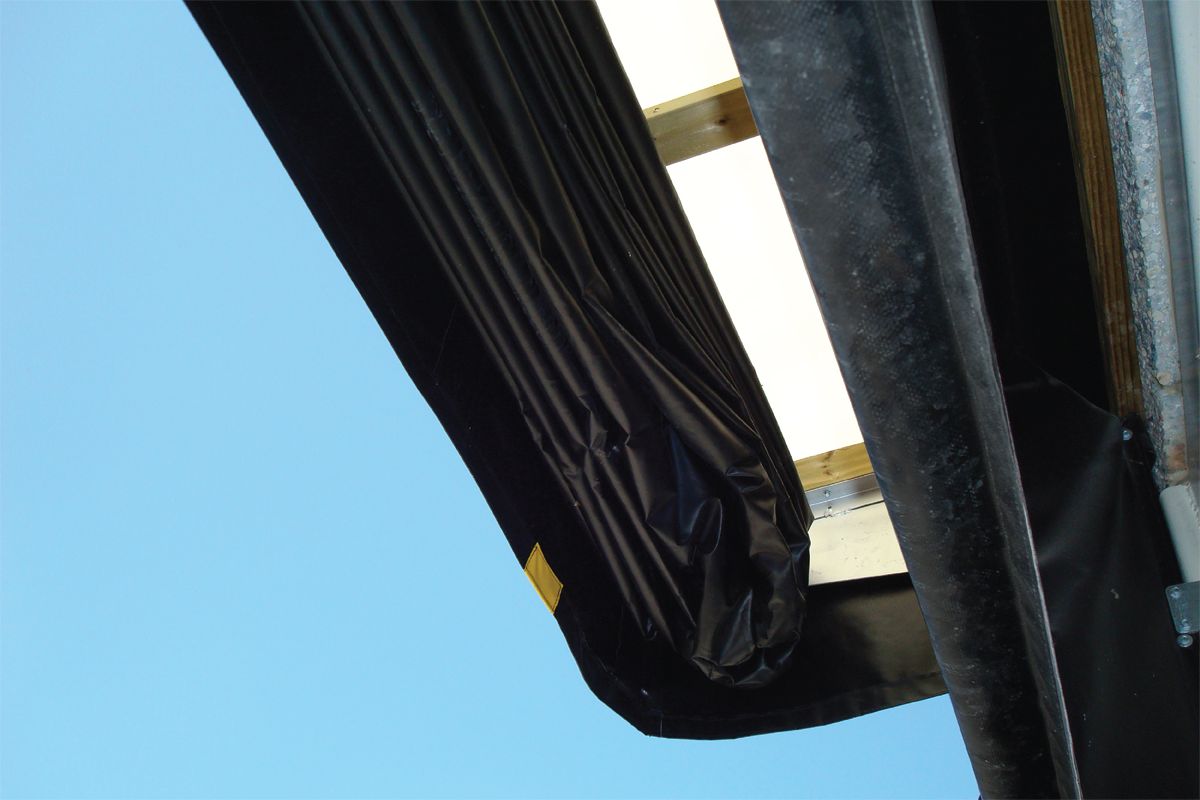 Image: Upward view of Serco SI-325 dock shelters with light filtering through the upper seal. 